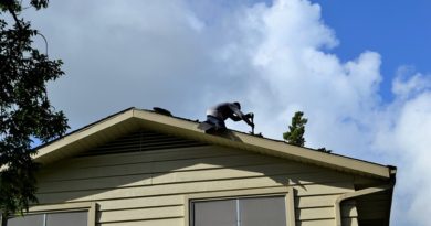 roofing contractor repairing roof shingles